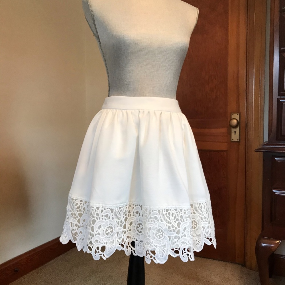 Cream skirt with lace hem.